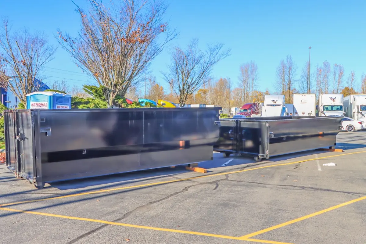 Professional dumpster rental service with roll-off container on residential driveway in Gladewater